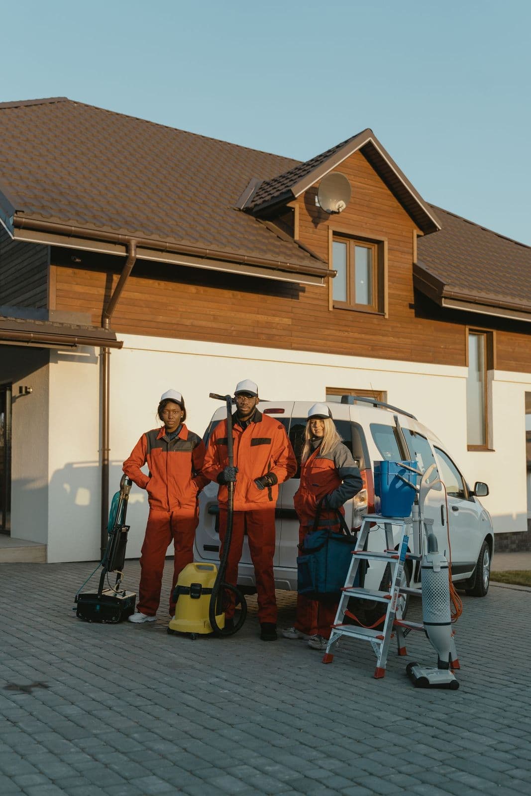 Cleaning crew with equipment arriving at a house